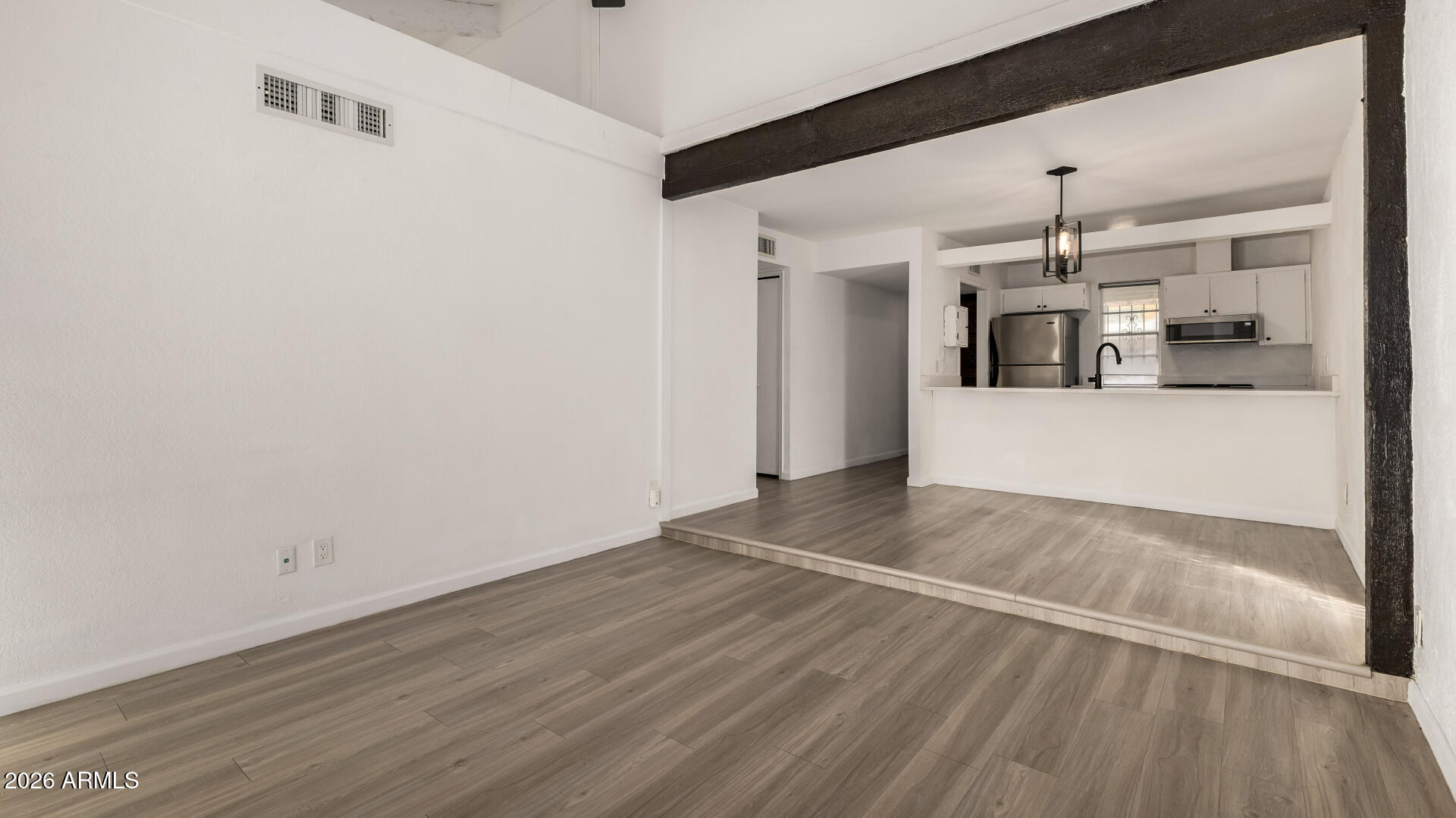 1149 East Rovey Avenue Phoenix, AZ 85014 - Photo 11 of 25 a view of a hallway with wooden floor and chandelier