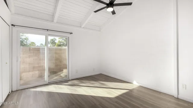 a view of an empty room with wooden floor