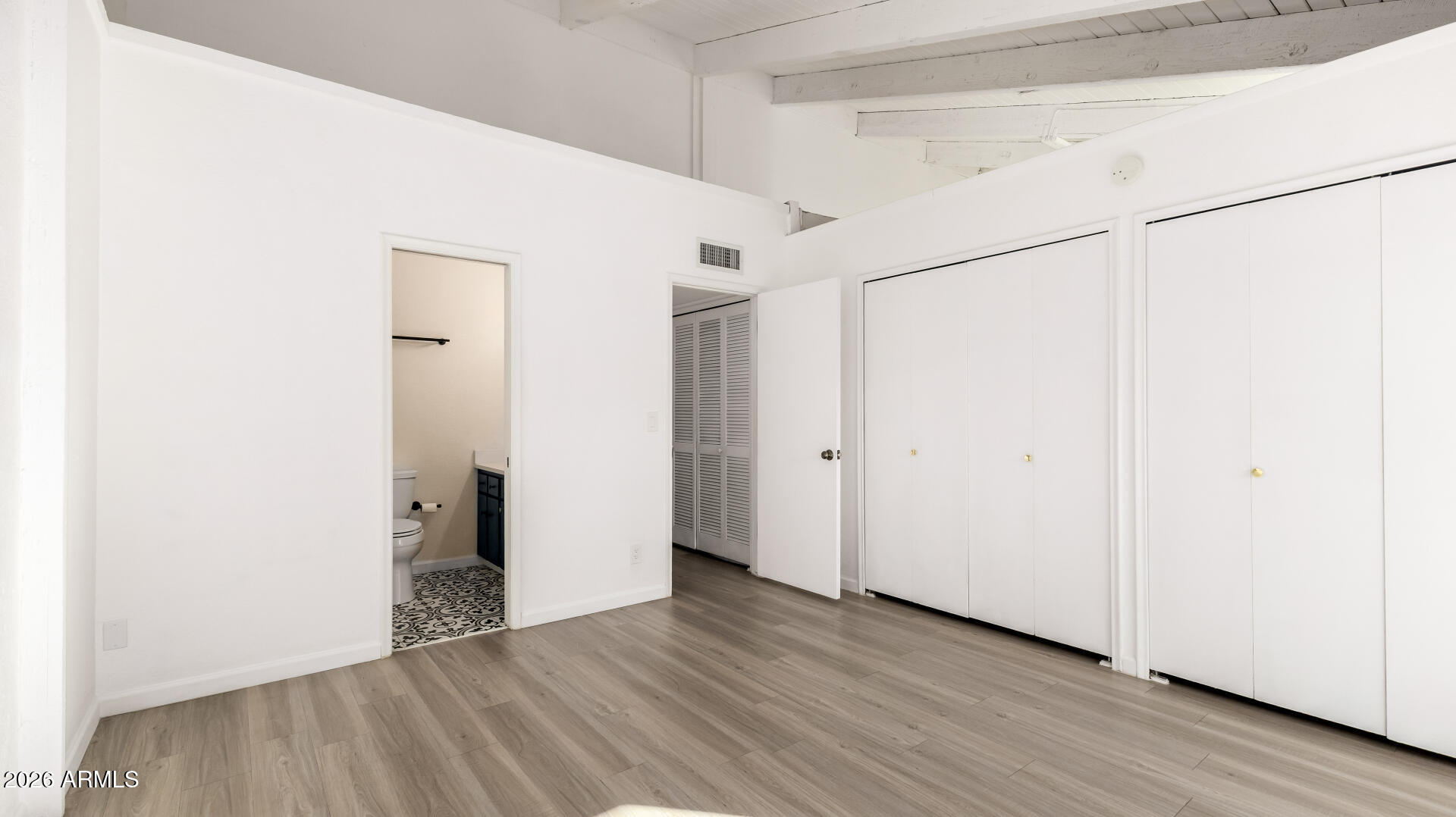 1149 East Rovey Avenue Phoenix, AZ 85014 - Photo 14 of 25 a view of an empty room with wooden floor
