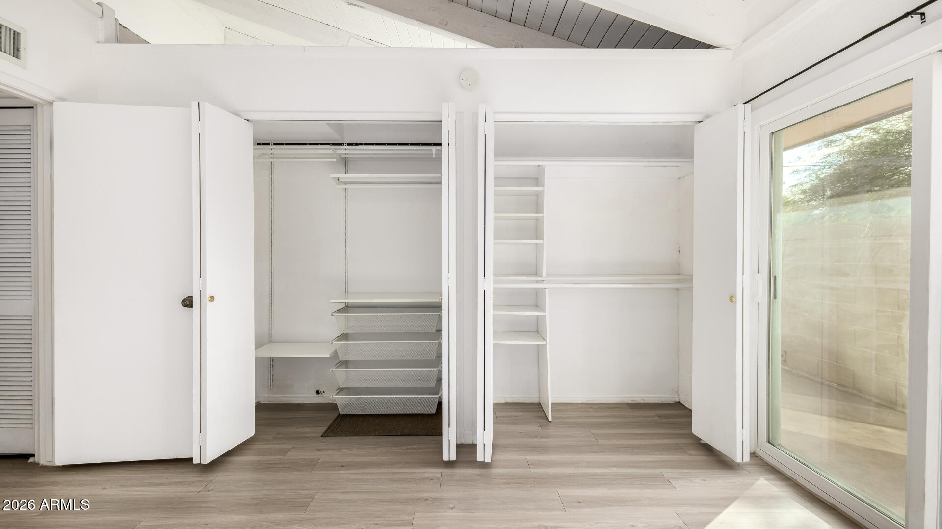 1149 East Rovey Avenue Phoenix, AZ 85014 - Photo 15 of 25 a view of a room with wooden floor and windows
