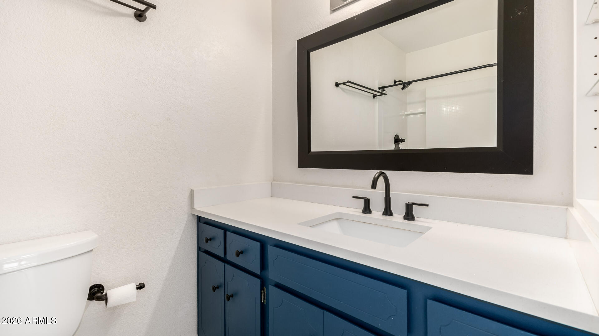 1149 East Rovey Avenue Phoenix, AZ 85014 - Photo 16 of 25 a bathroom with a sink and a mirror