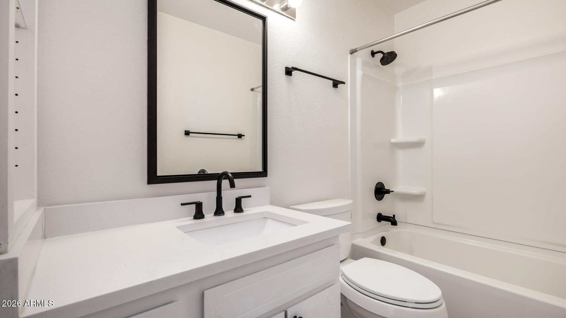 1149 East Rovey Avenue Phoenix, AZ 85014 - Photo 19 of 25 a bathroom with a sink a toilet a mirror and shower