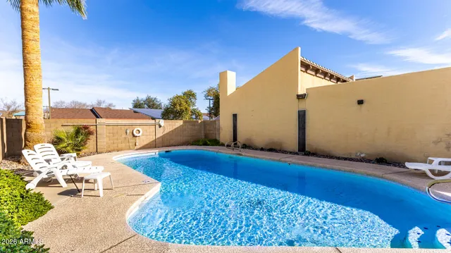 a view of swimming pool with seating area