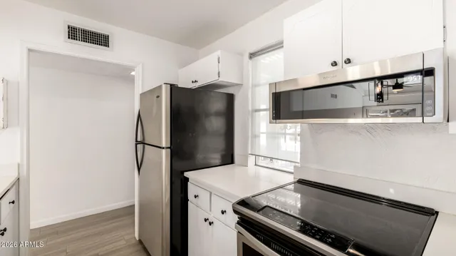 a kitchen with a sink and a refrigerator