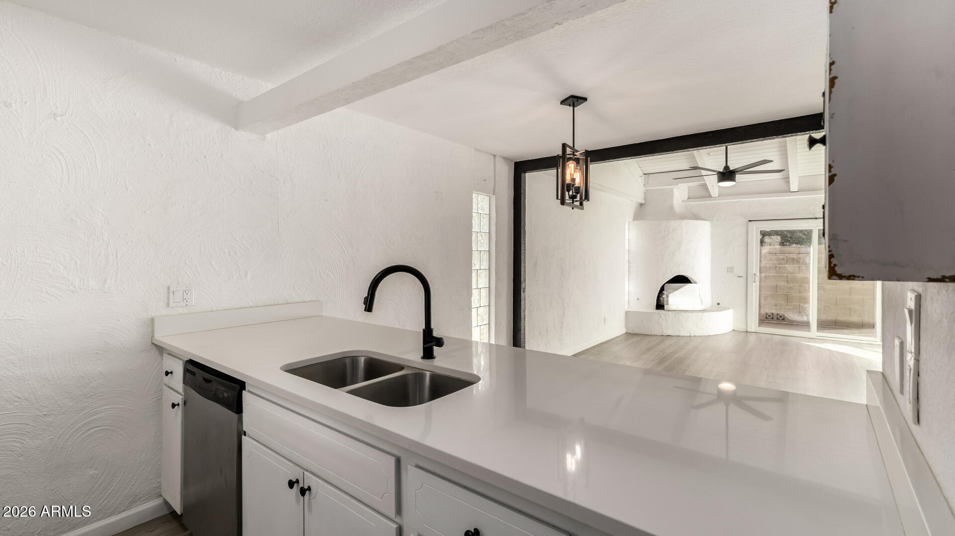 1149 East Rovey Avenue Phoenix, AZ 85014 - Photo 9 of 25 a kitchen with a sink and a refrigerator