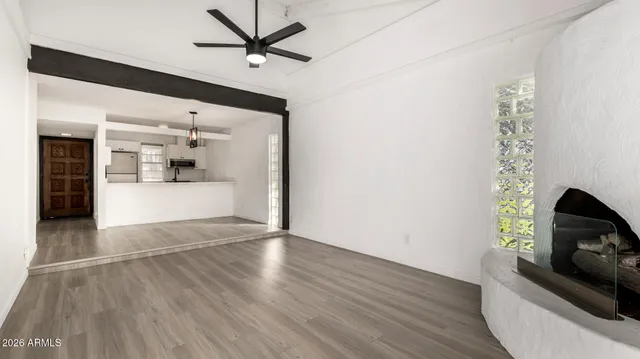 a view of a hallway with wooden floor and chandelier