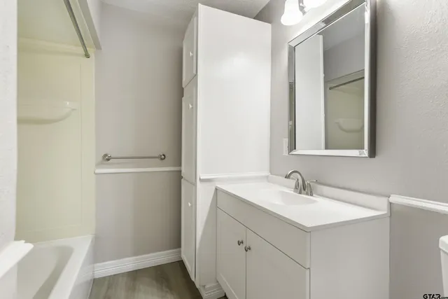 a bathroom with a sink a mirror and a shower