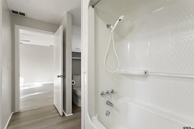 a bathroom with a bathtub and a shower