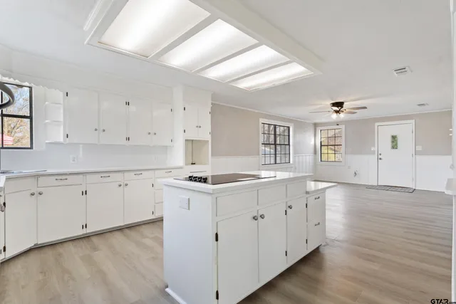 a kitchen with sink stove and cabinets