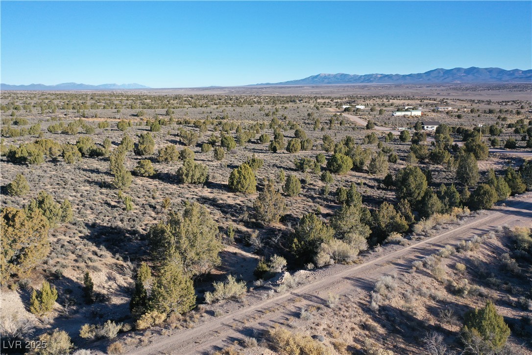 Aerial overview of property's location featuring a mountainous background and a desert landscape
