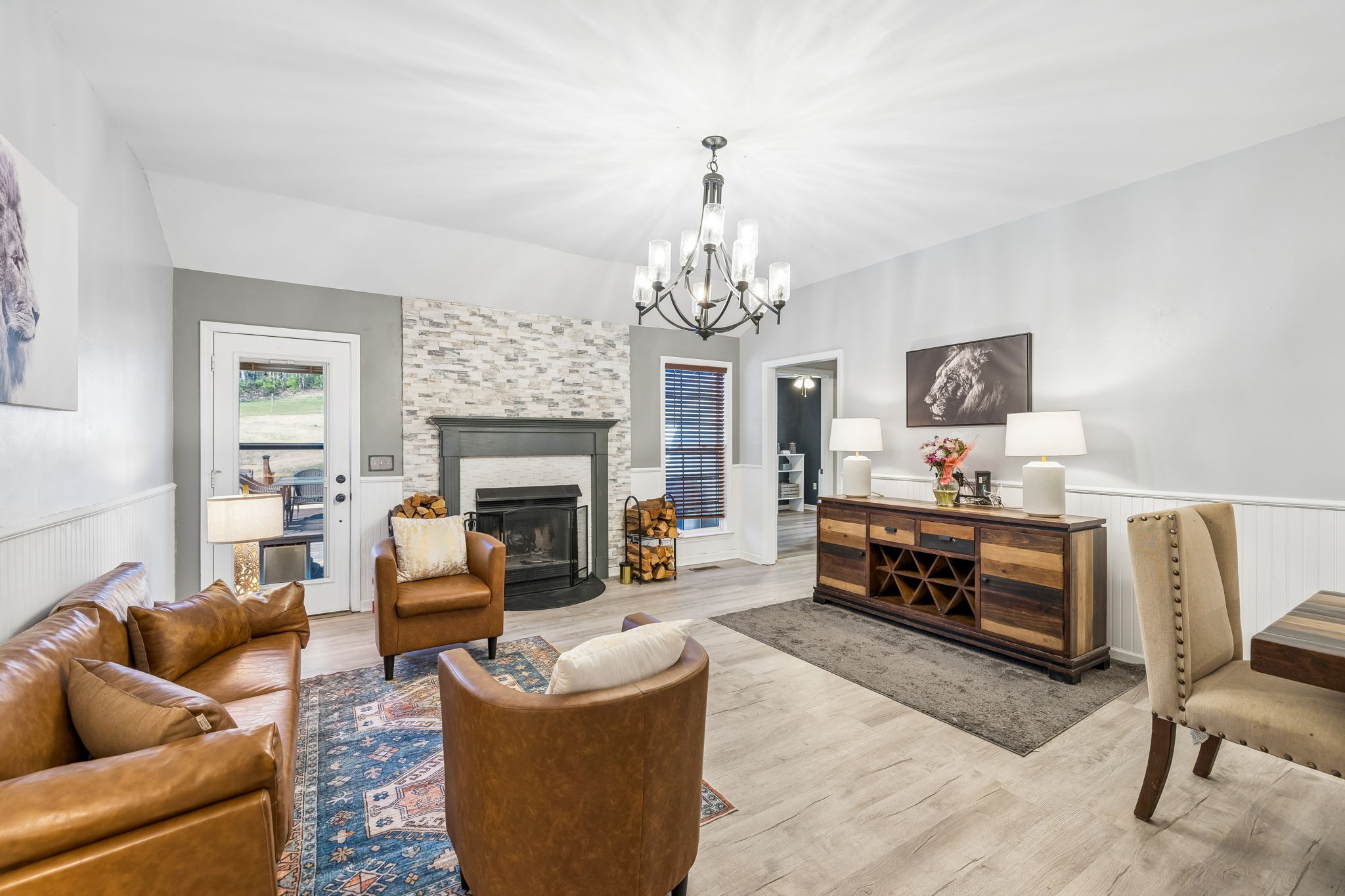 1245 Cliff Amos Road Spring Hill, TN 37174 - Photo 12 of 41 a living room with furniture a chandelier and a fireplace