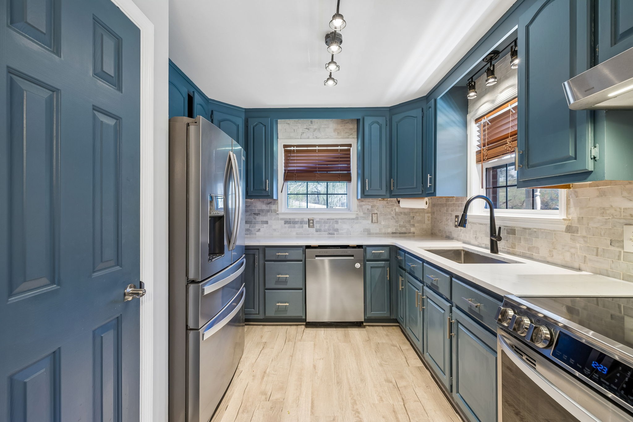 1245 Cliff Amos Road Spring Hill, TN 37174 - Photo 21 of 41 a kitchen with stainless steel appliances granite countertop a sink stove and refrigerator