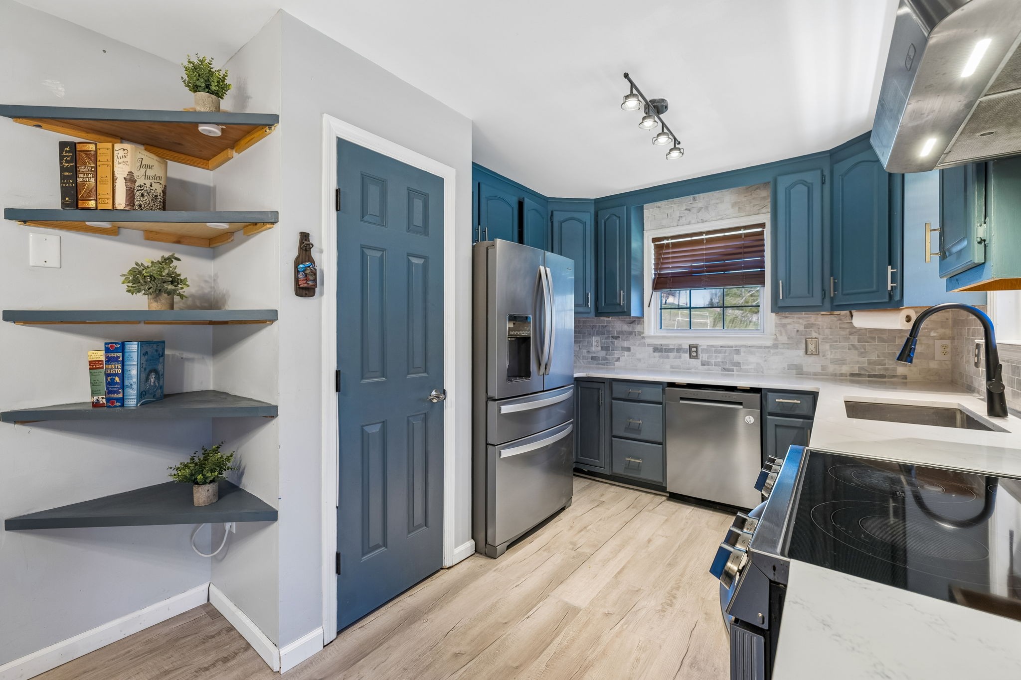1245 Cliff Amos Road Spring Hill, TN 37174 - Photo 22 of 41 a kitchen with kitchen island a counter top space a sink stainless steel appliances and cabinets