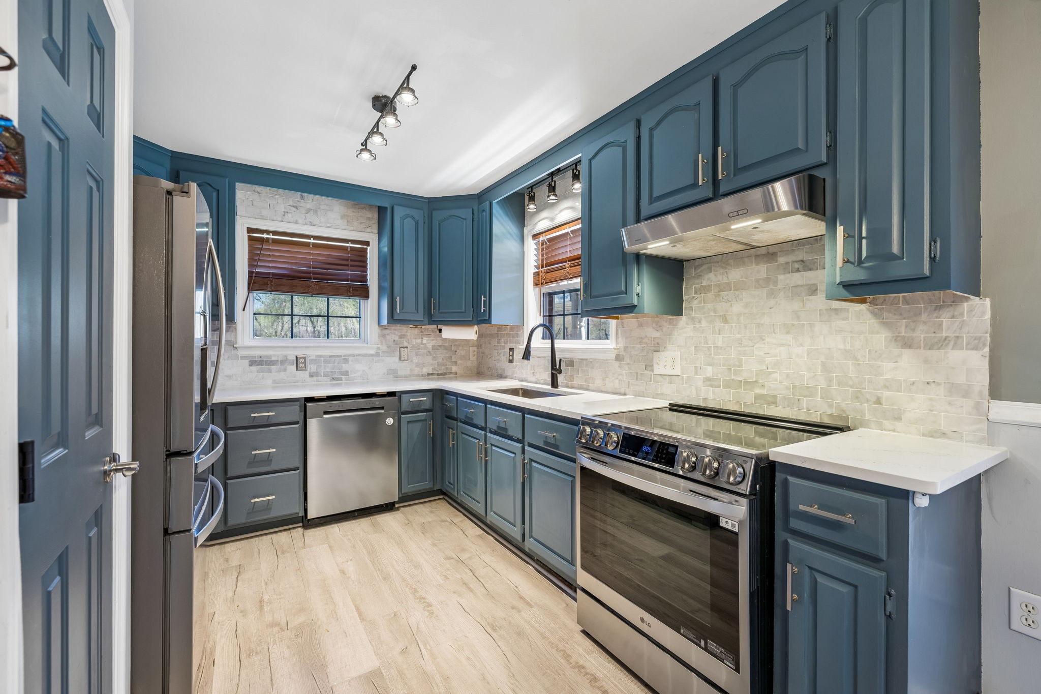 1245 Cliff Amos Road Spring Hill, TN 37174 - Photo 23 of 41 a kitchen with stainless steel appliances granite countertop wooden cabinets stove top oven and sink