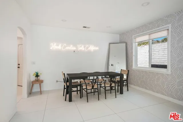 a kitchen with stainless steel appliances kitchen island granite countertop a stove a sink and a refrigerator