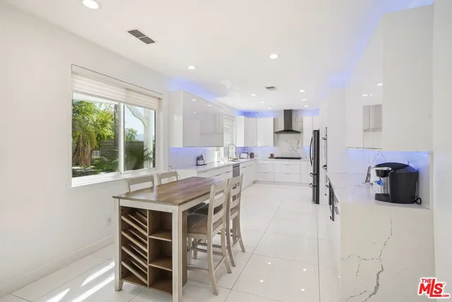 a kitchen that has a lot of cabinets in it and appliances