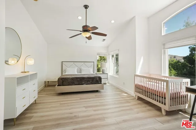 a bathroom with a granite countertop double vanity sink a large mirror and a bathtub with shower