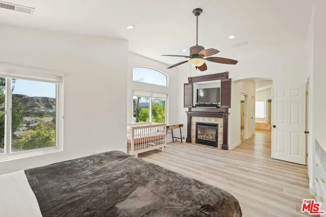 a spacious bathroom with a granite countertop sink a mirror and a shower