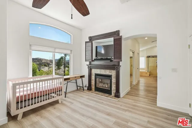 a spacious bedroom with a bed and a window