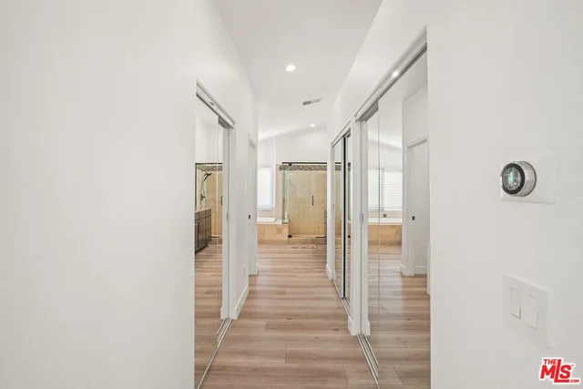 a bedroom with two bed and a flat screen tv