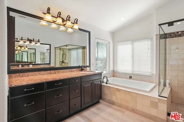 a living room with a bed and a chandelier