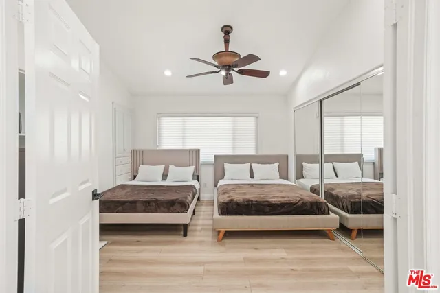 a bedroom with a bed and a ceiling fan
