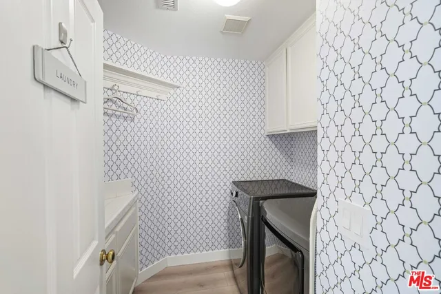 a bathroom with a double vanity sink mirror and shower