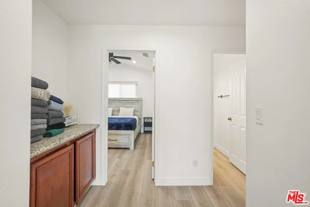 a view of a patio with table and chairs and a barbeque