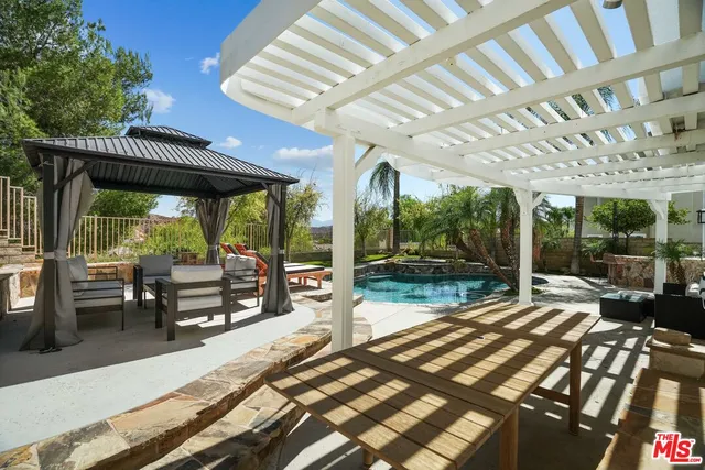 a room with furniture pool table and flat screen tv