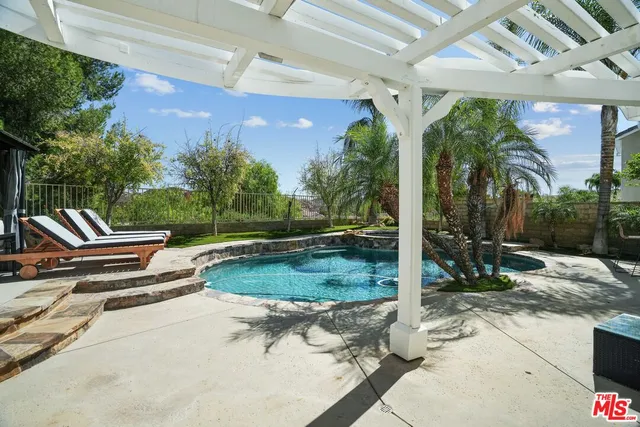 a view of a white house with a yard and table and chairs