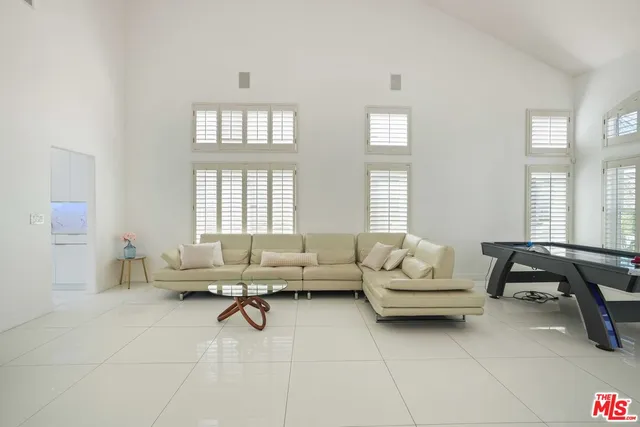 a living room with furniture a fireplace and a kitchen view