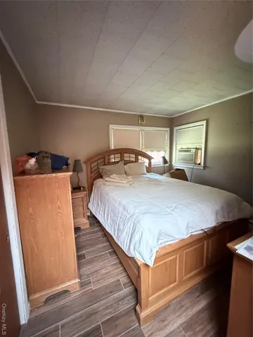 a bed sitting in a bedroom next to a window