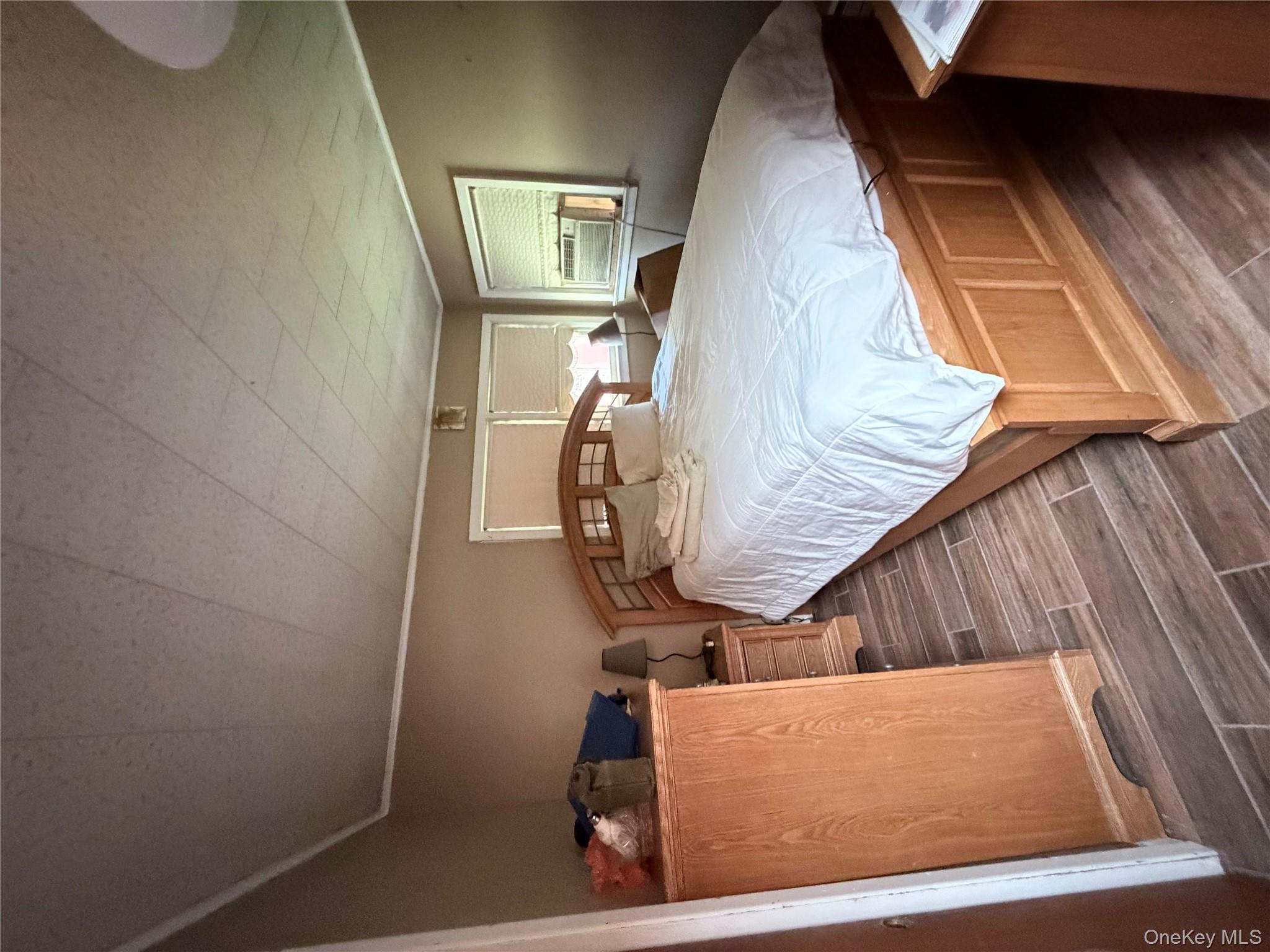 421 Nelson Road Monroe, NY 10950 - Photo 11 of 28 a bed sitting in a bedroom next to a window