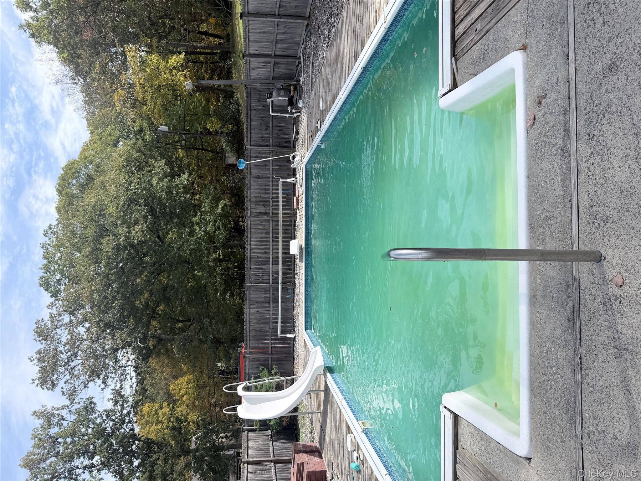 421 Nelson Road Monroe, NY 10950 - Photo 25 of 28 a view of a swimming pool with a patio