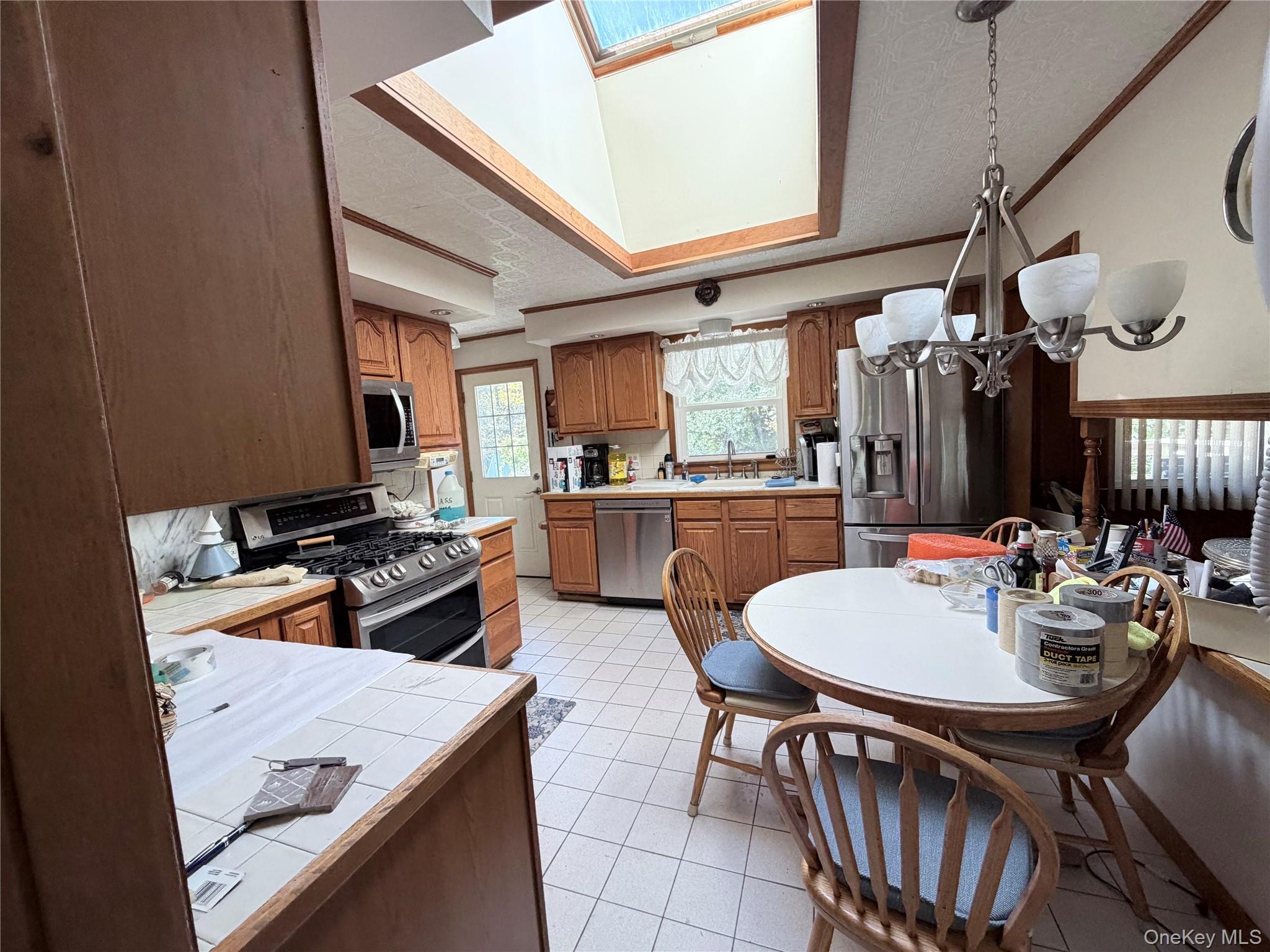 421 Nelson Road Monroe, NY 10950 - Photo 28 of 28 a kitchen with a dining table and chairs