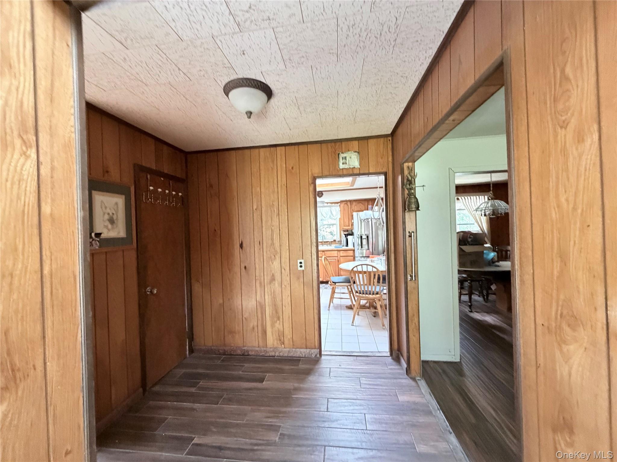 421 Nelson Road Monroe, NY 10950 - Photo 4 of 28 a view of a hallway with wooden floor and a bathroom