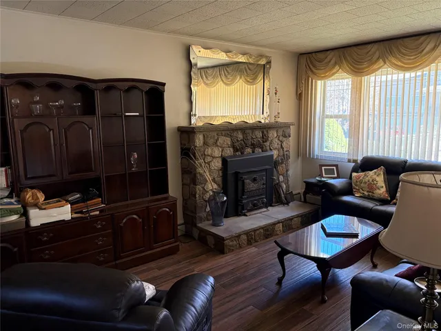 a living room with furniture fireplace and a large window