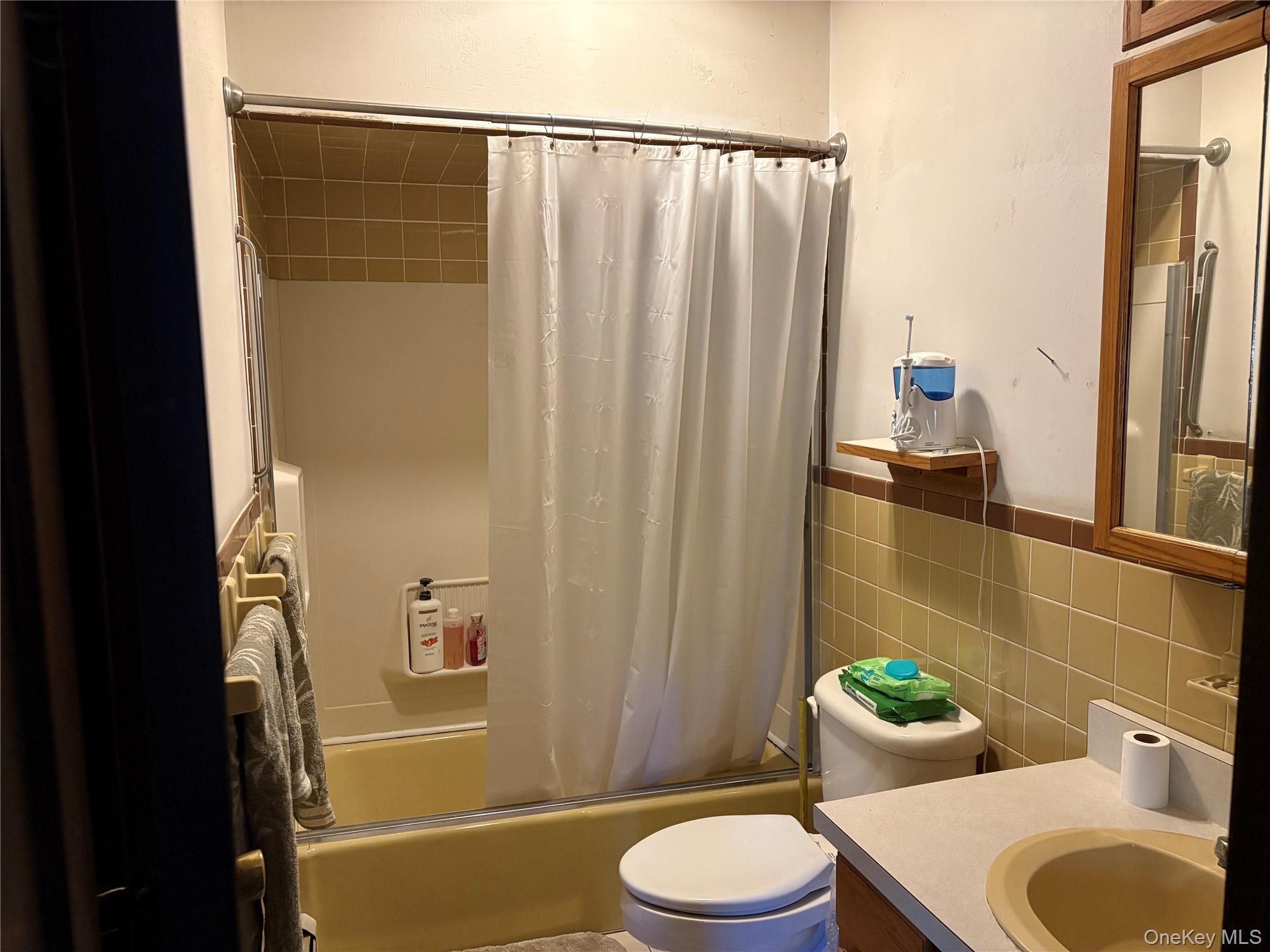 421 Nelson Road Monroe, NY 10950 - Photo 7 of 28 a bathroom with a sink a toilet a tub and shower