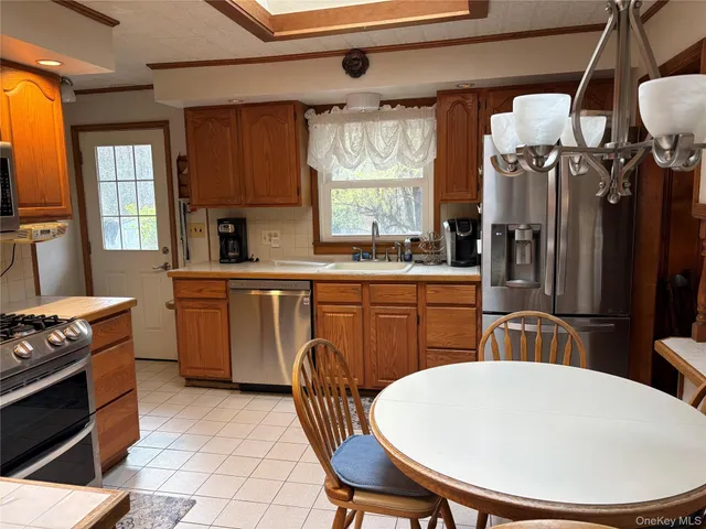 a kitchen with a sink appliances and cabinets