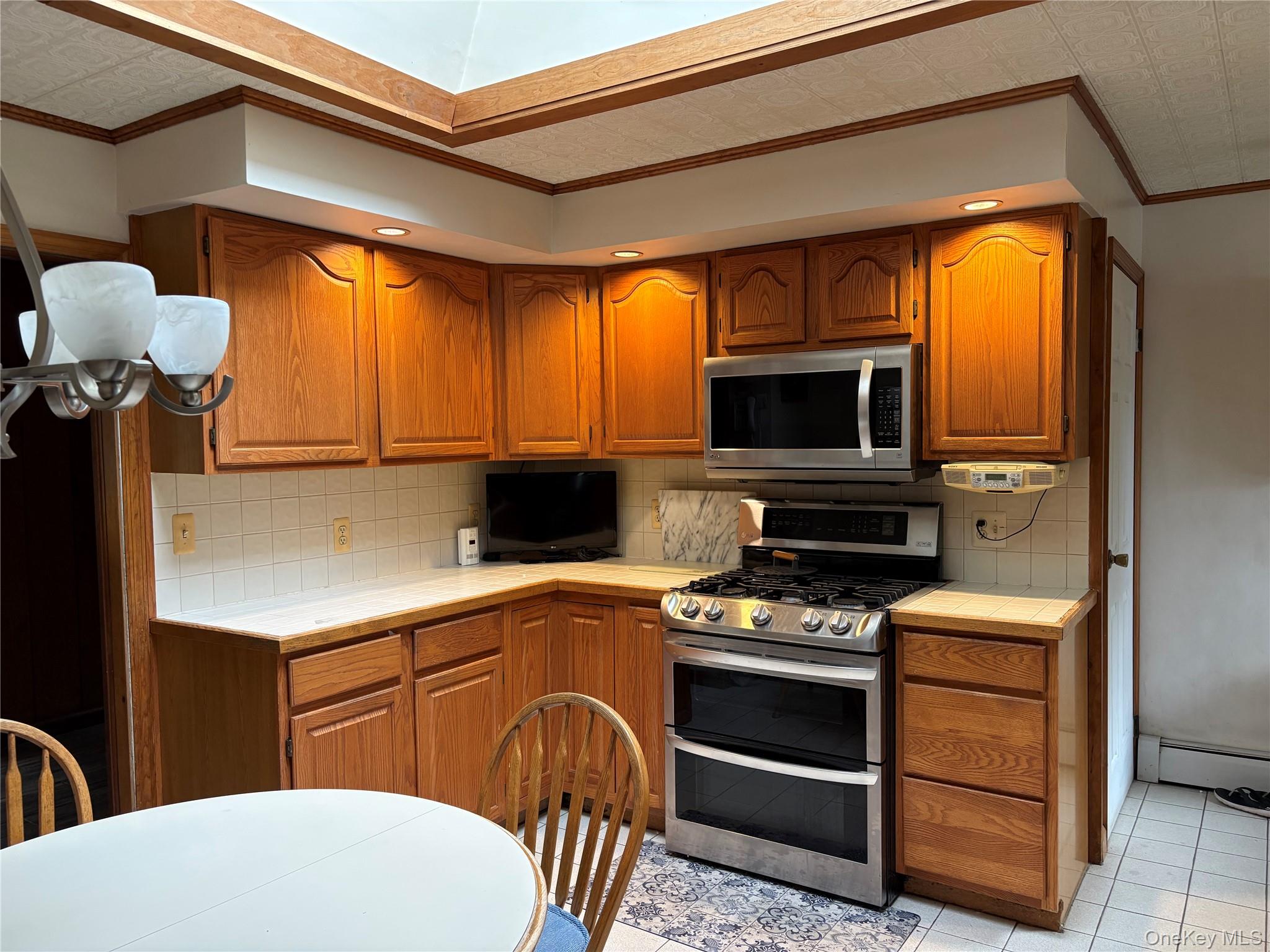 421 Nelson Road Monroe, NY 10950 - Photo 9 of 28 a kitchen with a stove a microwave and a counter top space