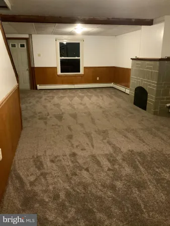a view of an empty room with a fireplace