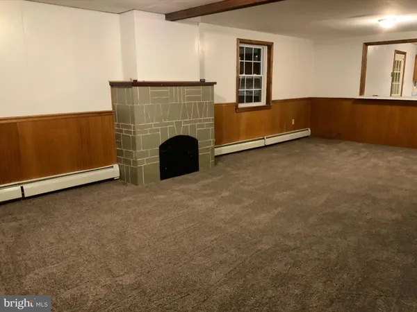 a view of an empty room with a fireplace