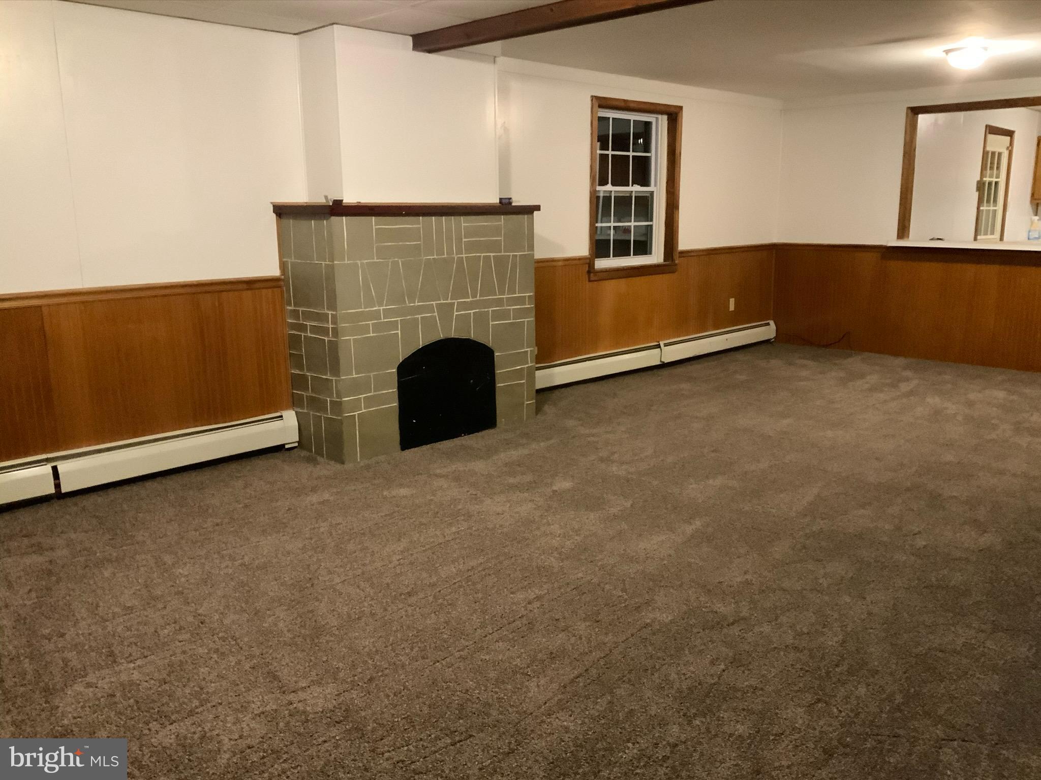 123 East Spring Street Frackville, PA 17931 - Photo 6 of 16 a view of an empty room with a fireplace