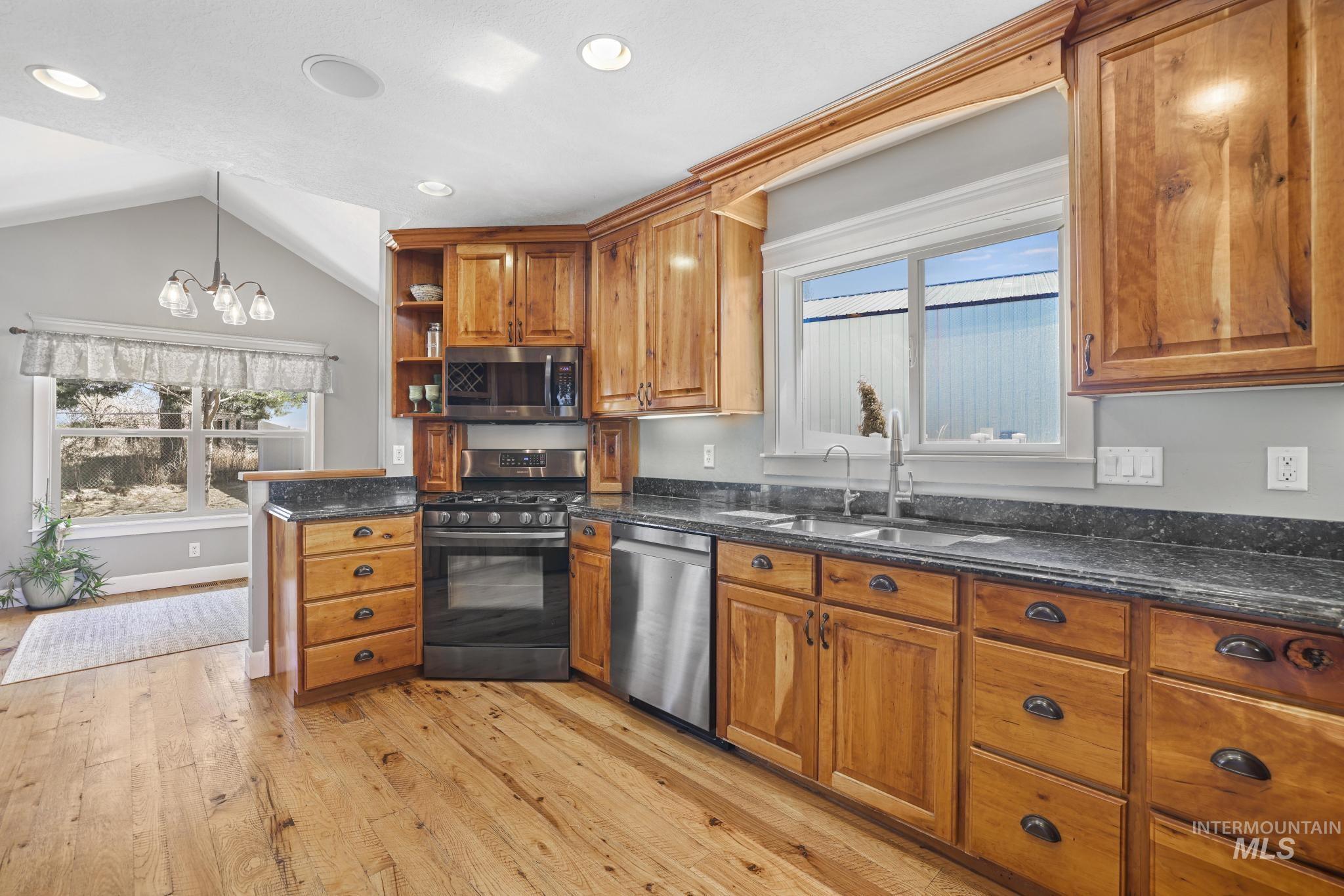 1111 Cole Street Kimberly, ID 83341 - Photo 11 of 46 Kitchen with stainless steel appliances, wood finish cabinets, light wood-type flooring, open shelves, and healthy amount of natural light