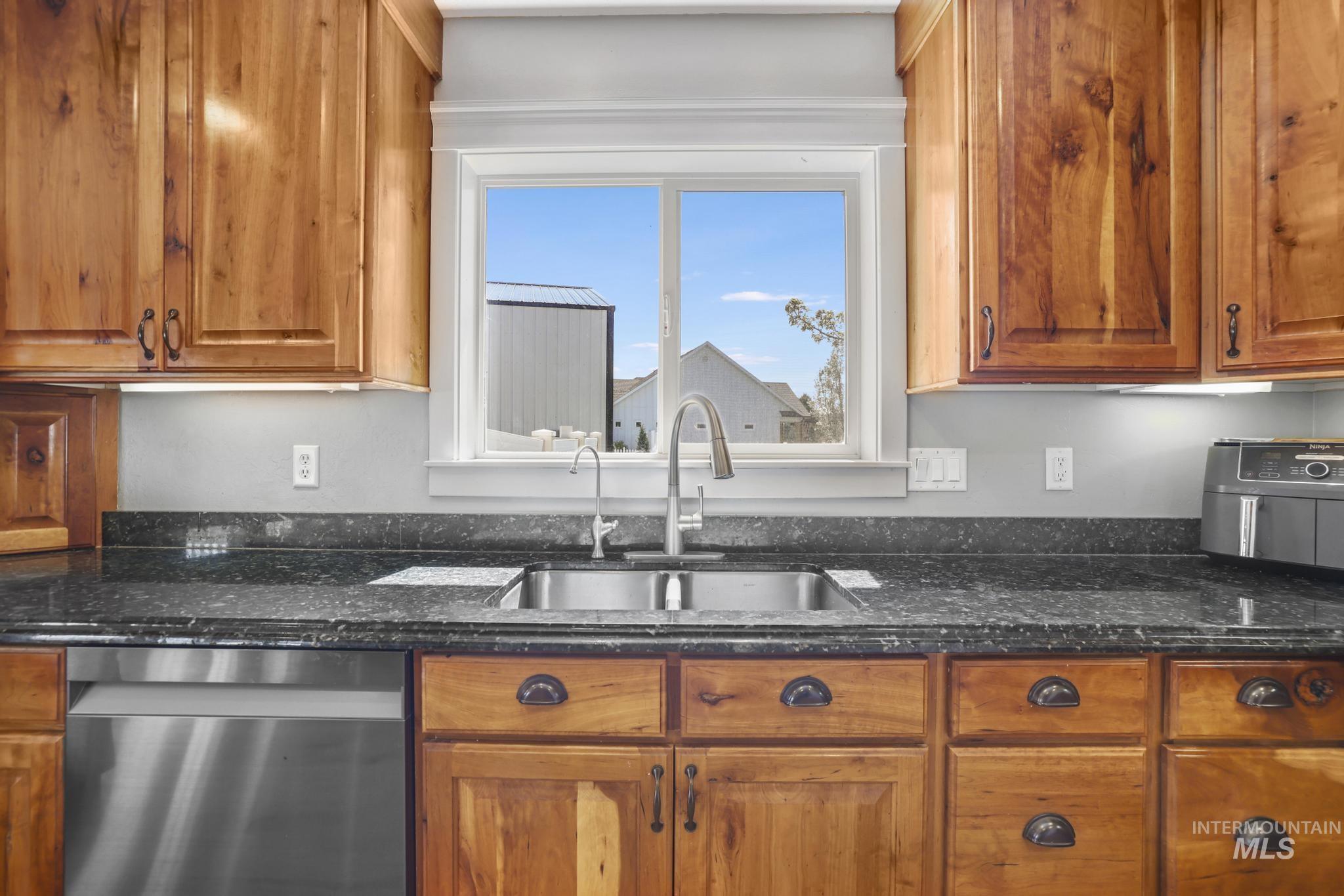 1111 Cole Street Kimberly, ID 83341 - Photo 12 of 46 Kitchen with wood finish cabinets, dishwasher, and dark stone counters