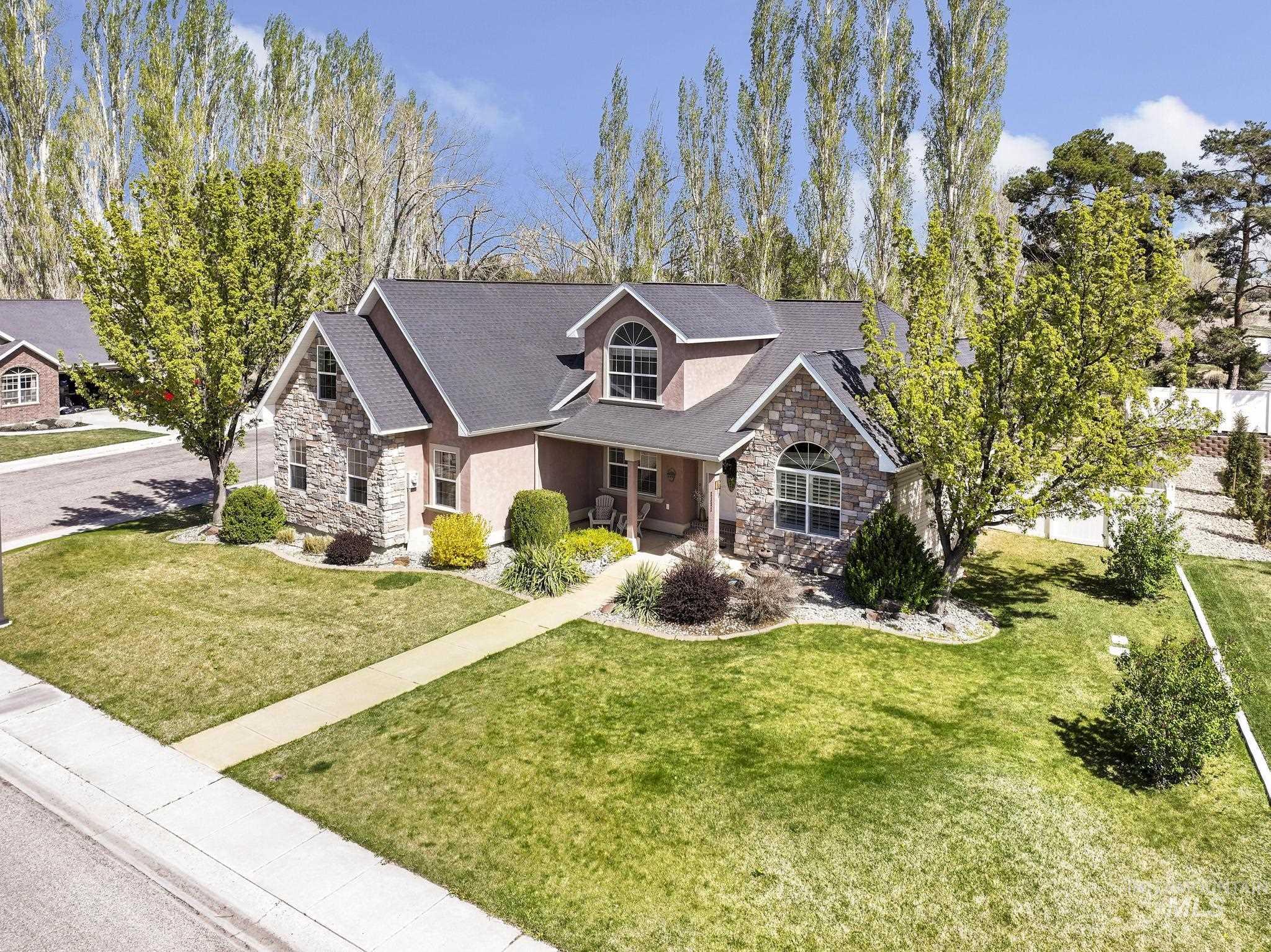 1111 Cole Street Kimberly, ID 83341 - Photo 2 of 46 View of front of house with stone siding, covered porch, a front lawn, and a shingled roof