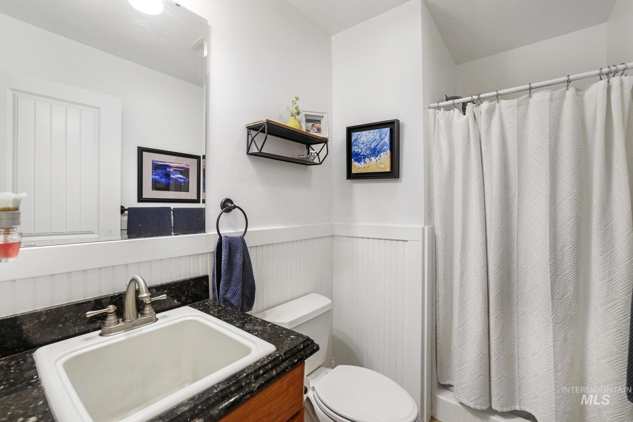 1111 Cole Street Kimberly, ID 83341 - Photo 25 of 46 Bathroom featuring a wainscoted wall, a shower with shower curtain, and vanity