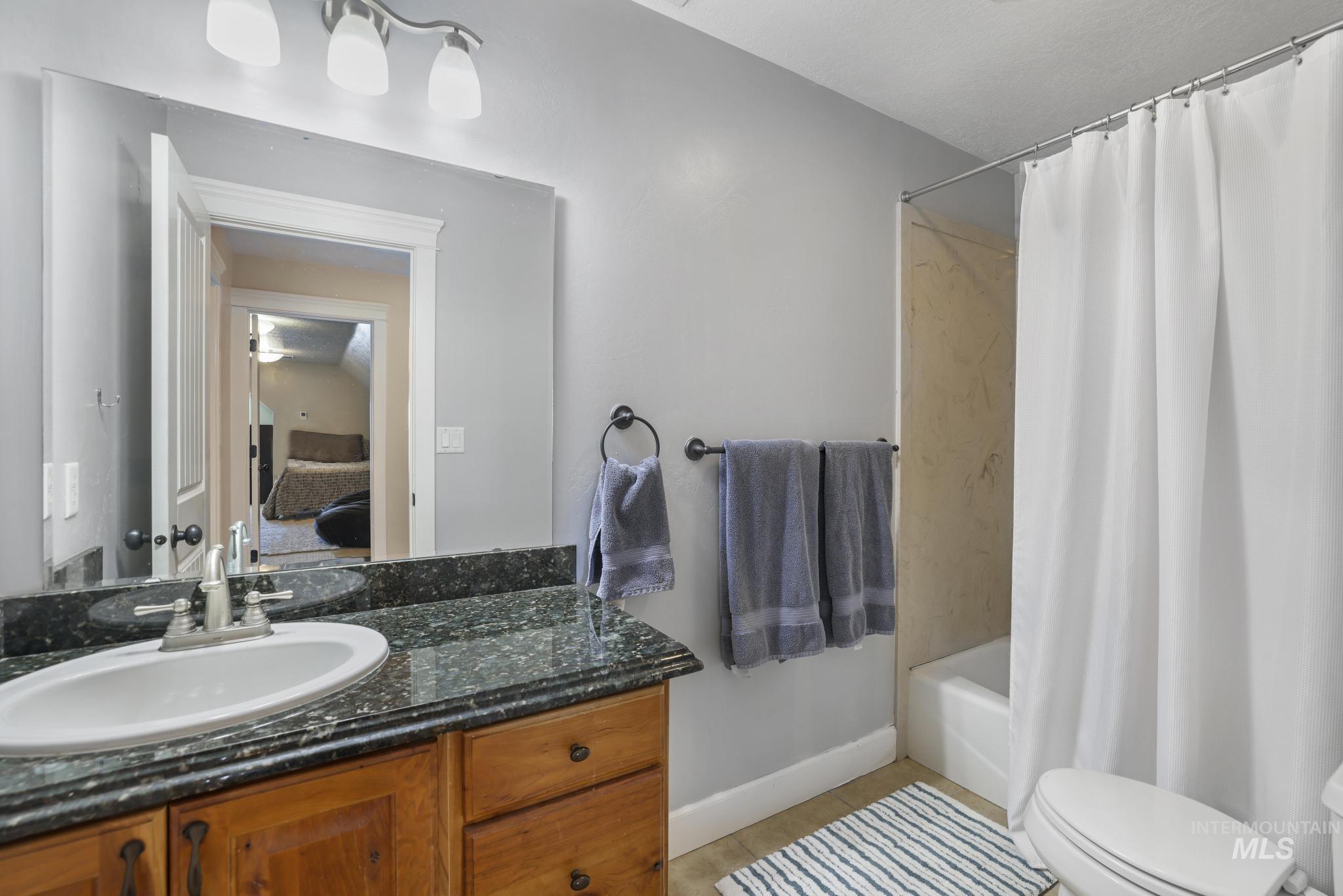 1111 Cole Street Kimberly, ID 83341 - Photo 27 of 46 Ensuite bathroom with vanity, light tile patterned flooring, and shower / bath combo