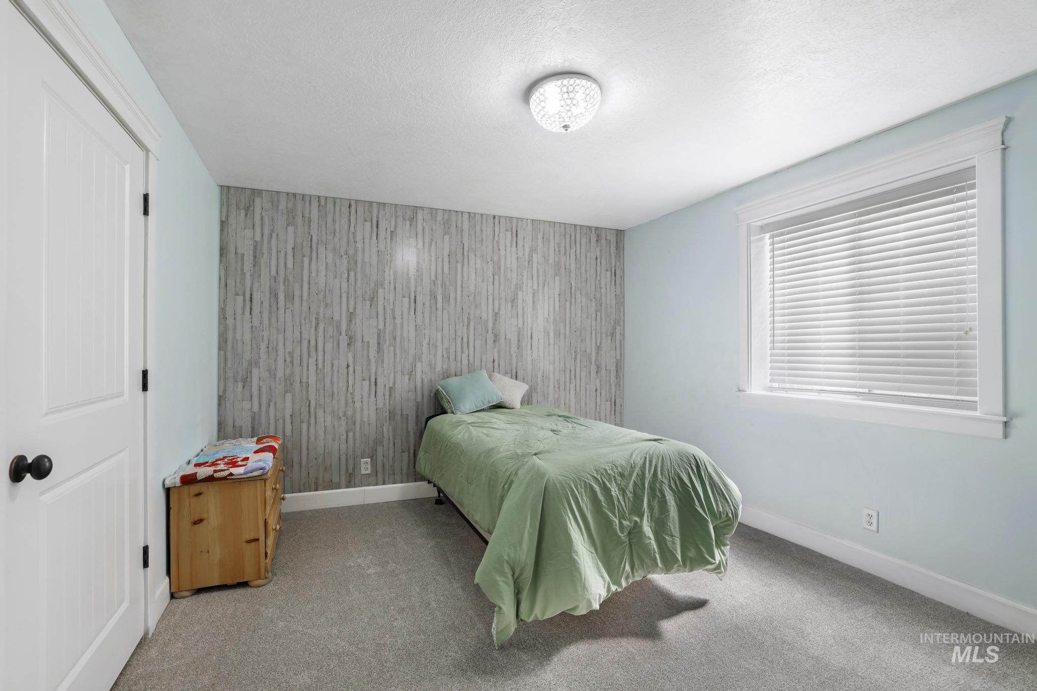 1111 Cole Street Kimberly, ID 83341 - Photo 36 of 46 Bedroom with an accent wall and carpet