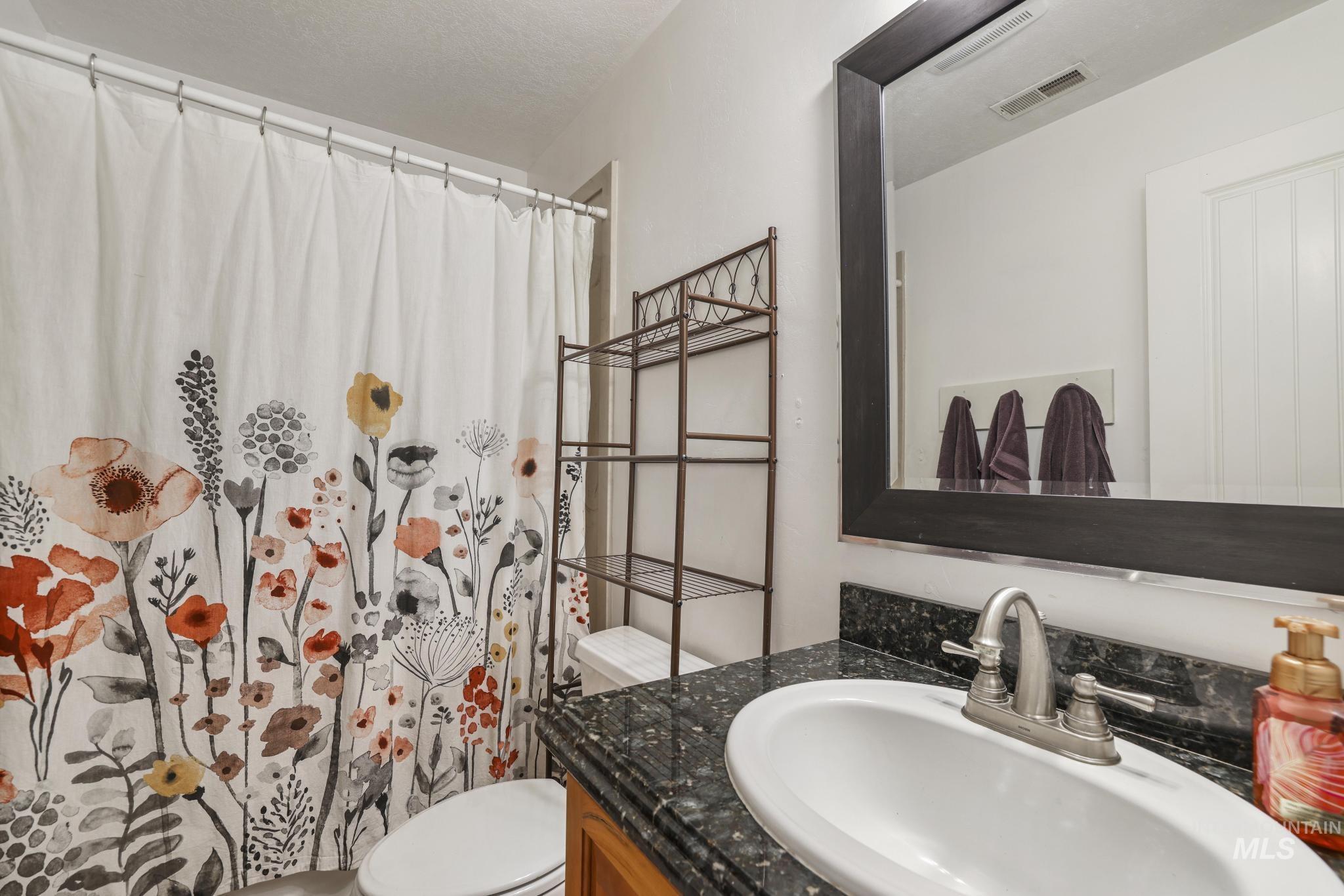 1111 Cole Street Kimberly, ID 83341 - Photo 37 of 46 Bathroom with vanity and a shower with shower curtain